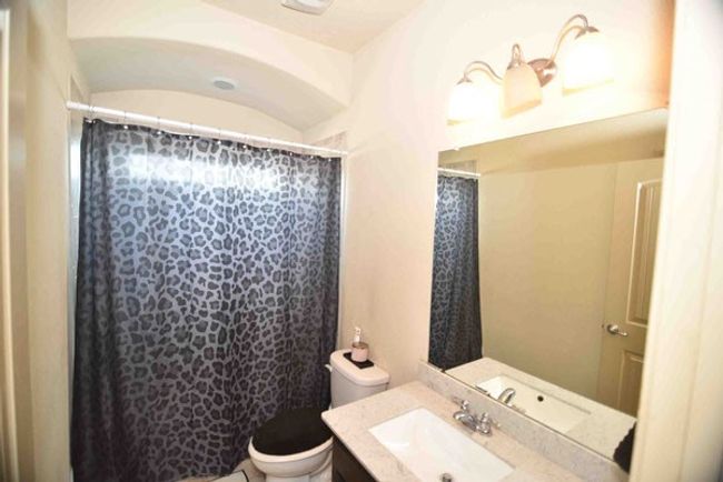 Full bath with vanity, toilet, and curtained shower | Image 28