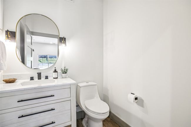 Half bathroom featuring vanity and toilet | Image 11