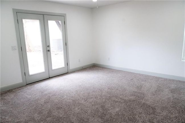 Empty room featuring french doors, carpet, and baseboards | Image 9