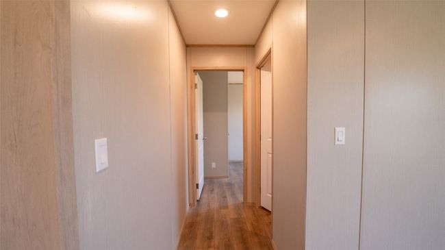 Hallway with wood finished floors and recessed lighting | Image 19