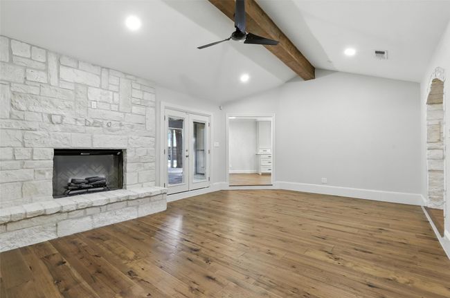 Unfurnished living room featuring a ceiling fan, hardwood / wood-style flooring, a fireplace, and recessed lighting | Image 12
