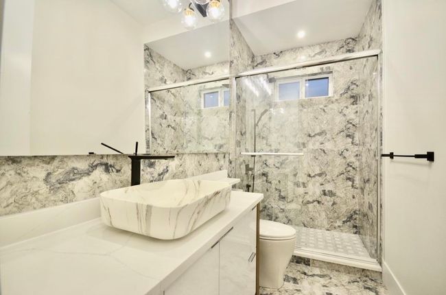 Full bathroom featuring vanity and a marble finish shower | Image 21