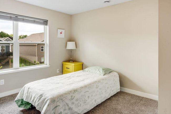 The fourth bedrooms is located upstairs and overlooks the backyard | Image 15