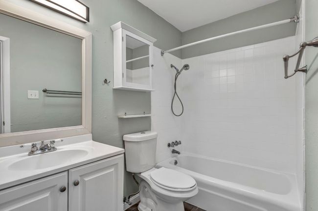 Bathroom with toilet, shower / bath combination, and vanity | Image 17