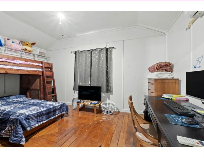 Bedroom featuring lofted ceiling, a desk, and wood finished floors | Image 37