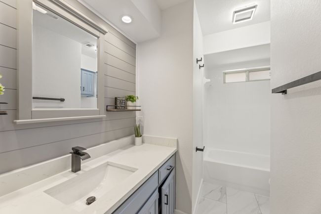 Bathroom featuring marble finish floor, visible vents, vanity, and bathing tub / shower combination | Image 22