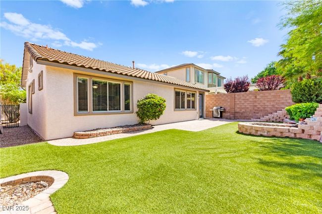 Back of house with stucco siding, a tiled roof, and a patio area | Image 43