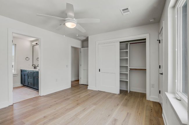 Unfurnished bedroom featuring light wood-style floors, a closet, ensuite bathroom, and a sink | Image 20