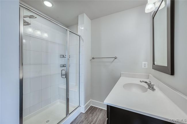 Bathroom with vanity, a shower stall, and wood finished floors | Image 23