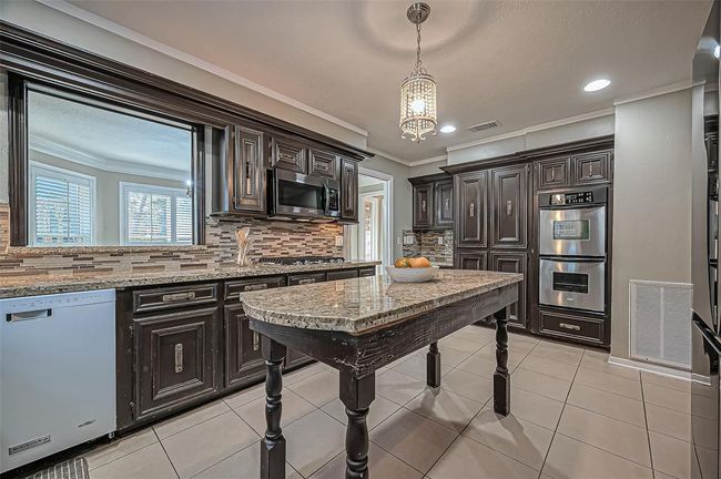 Charming passthrough window to the elegant dining room. | Image 21