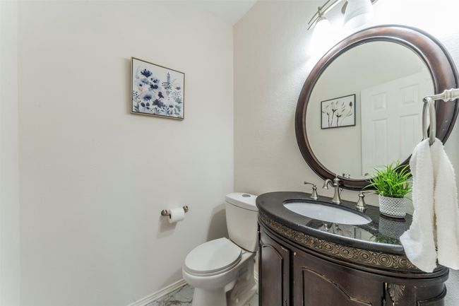 Bathroom with vanity and marble look tile flooring | Image 19