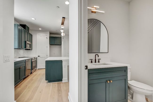 Full bath featuring two vanities, wood finished floors, recessed lighting, toilet, and tasteful backsplash | Image 16
