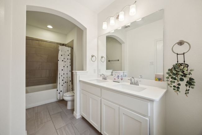 Full bathroom with toilet, double vanity, a sink, and visible vents | Image 18
