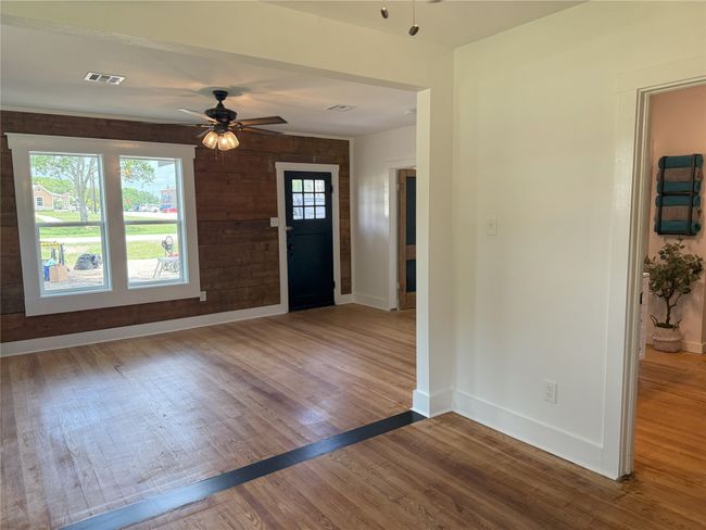 Foyer entrance with wood finished floors and ceiling fan | Image 9