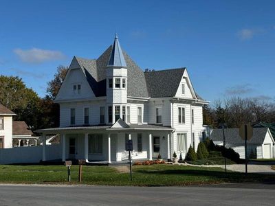 Victorian-style house featuring a front yard and covered porch | Image 1