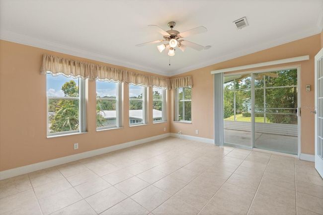 Ceramic Tile Air-Conditioned Florida Room with entry from Living Area and Main Bedroom Suite, looking onto outside screened porch. | Image 15