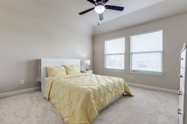 Bedroom featuring light colored carpet and a ceiling fan | Image 16