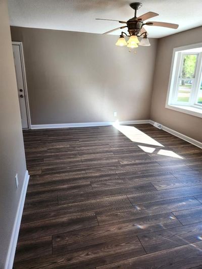 Empty room featuring dark hardwood / wood-style floors and ceiling fan | Image 3