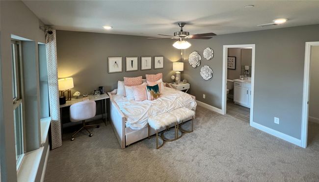 Bedroom featuring carpet, a ceiling fan, connected bathroom, and an office area | Image 21