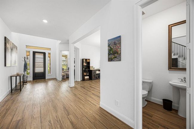 Across from the stairs sits the half bathroom. | Image 17