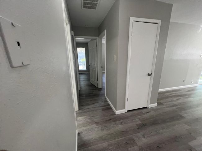 Corridor featuring baseboards and wood finished floors | Image 11