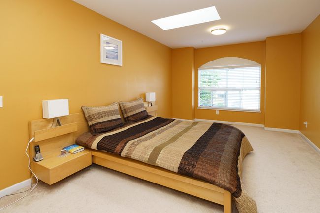 Bedroom with a skylight, light carpet, and baseboards | Image 19
