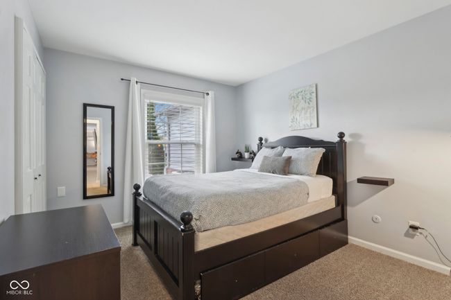 bedroom with dark carpet and baseboards | Image 16