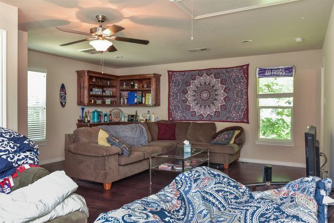 Living room featuring ceiling fan and hardwood / wood-style flooring | Image 7