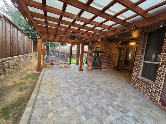 Fenced backyard featuring a patio area, a ceiling fan, a pergola, and an outdoor fire pit | Image 14