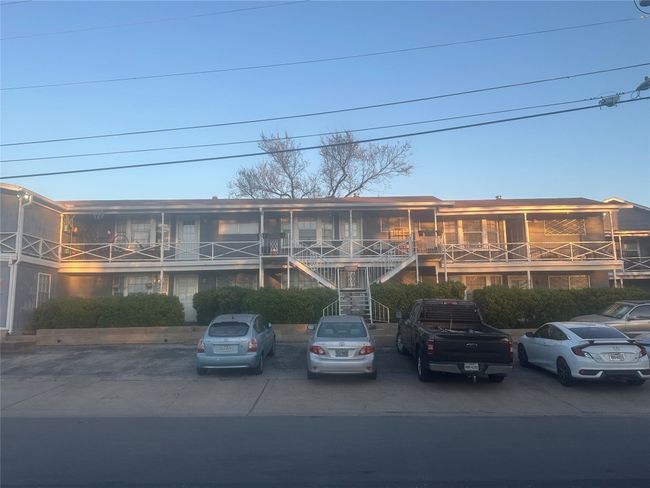 View of property featuring uncovered parking and stairway | Image 6