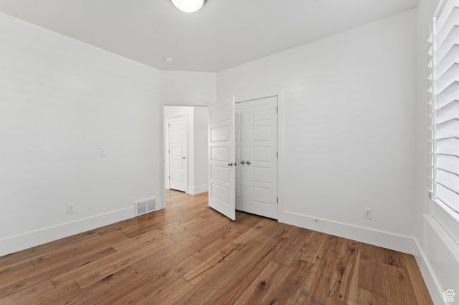 Unfurnished bedroom featuring light wood-style flooring and baseboards | Image 21