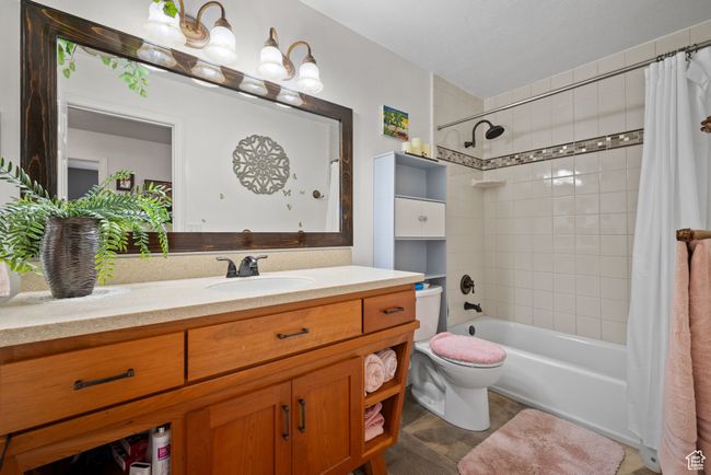Bathroom featuring shower / tub combo, toilet, and vanity | Image 18