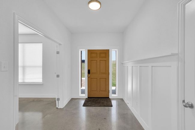 Foyer featuring concrete floors and baseboards | Image 12