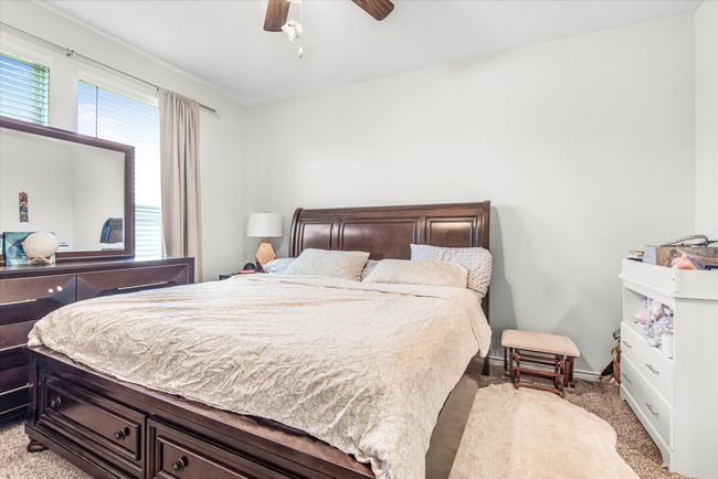Bedroom with a ceiling fan, baseboards, and carpet flooring | Image 14