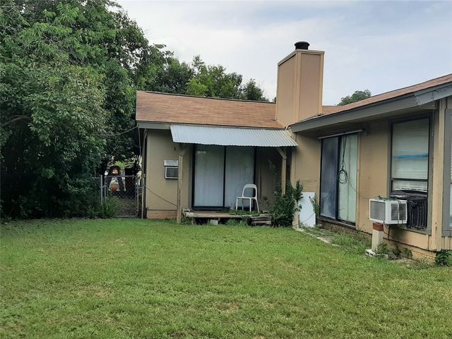 Rear view of house featuring a chimney and a gate | Image 21