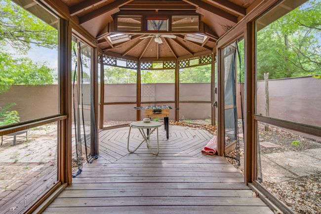 Unfurnished sunroom featuring lofted ceiling | Image 27