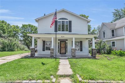 View of front of house with covered porch and a front yard | Image 1