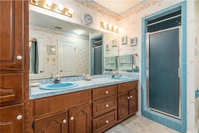 Bathroom featuring separate shower, double vanity and his and her closets | Image 25