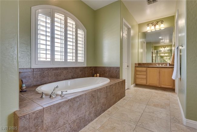 Bathroom with a bath, baseboards, visible vents, and vanity | Image 48