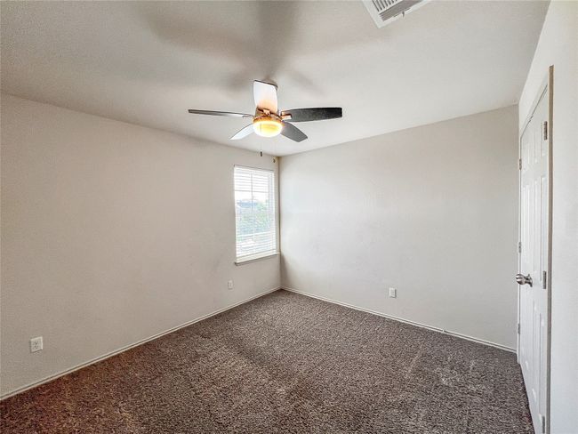 Carpeted spare room featuring a ceiling fan and baseboards | Image 15