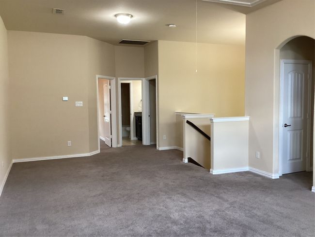 Unfurnished room with carpet, baseboards, and arched walkways | Image 24