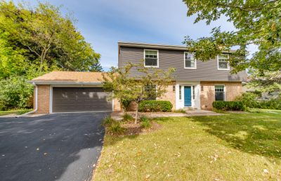 A beautifully landscaped front yard sets the tone for the elegance found within. | Image 1