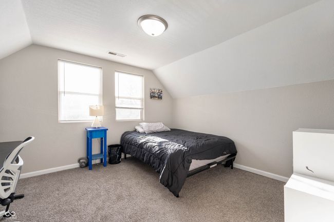 bedroom featuring visible vents, carpet floors, and lofted ceiling | Image 13