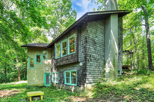 Side view of home's exterior with a chimney | Image 16