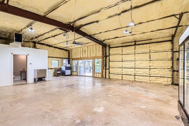 A 1, 200 sq ft workshop offers both utility and comfort, complete with heating and cooling, foam insulation, a commercial sink, and a full tiled bath, making it a dream space for work or play. | Image 26