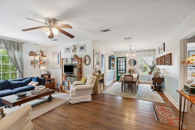 Main living area and dining area with original hardwood floors | Image 7
