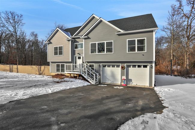 Bi-level home featuring a garage | Image 32