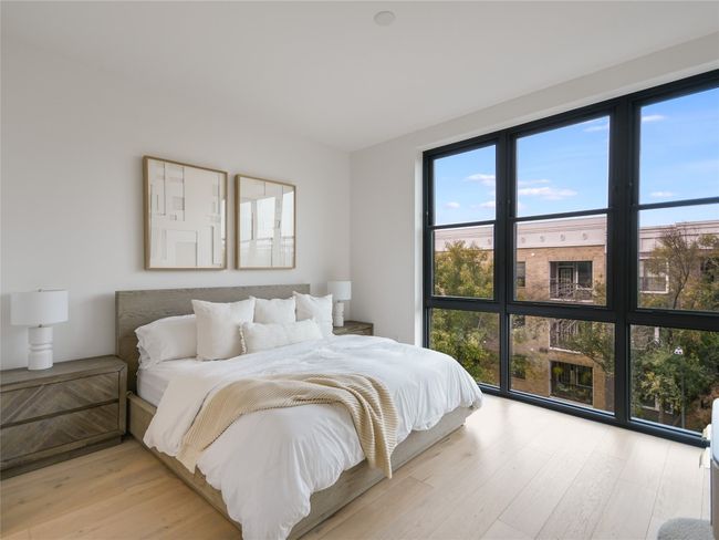 Bedroom with light wood finished floors | Image 13
