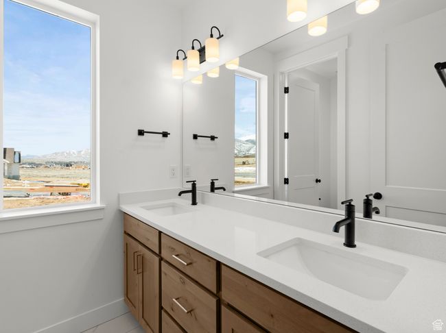 Full bathroom with double vanity, baseboards, and a sink | Image 11