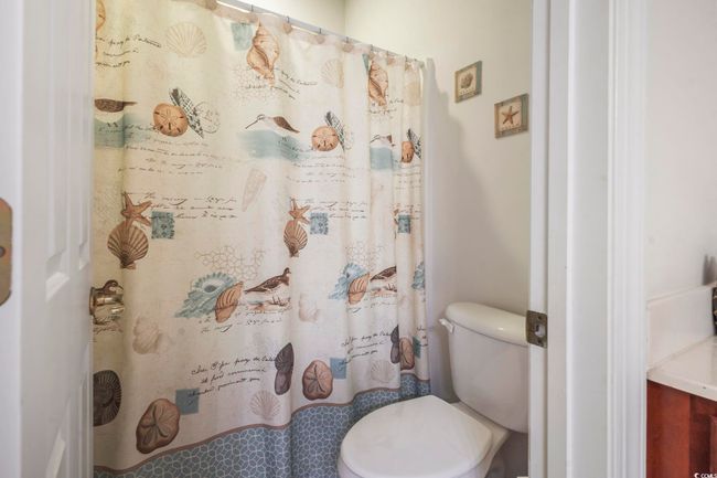 Bathroom featuring curtained shower | Image 13